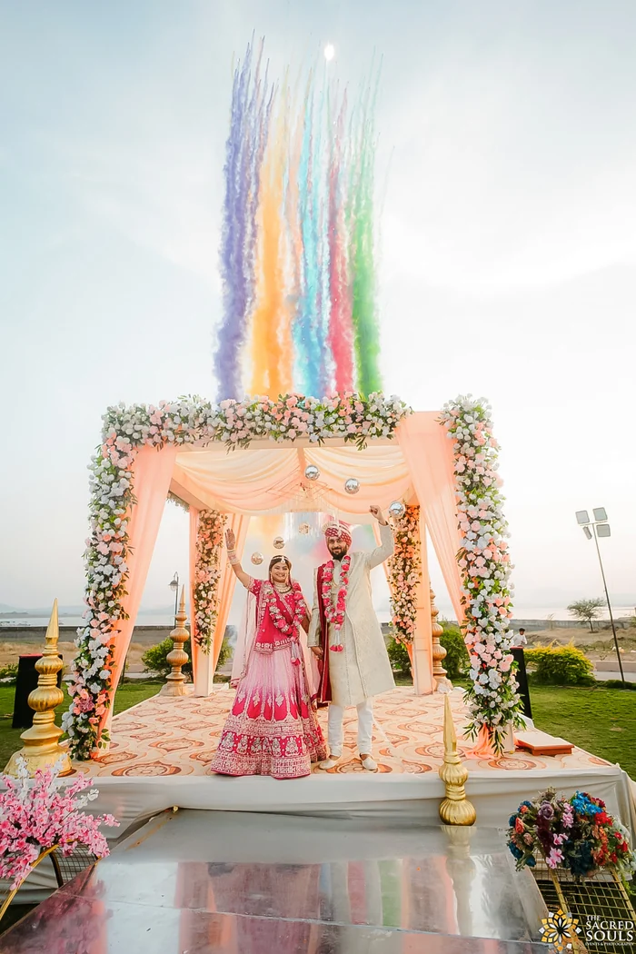 A wedding stage under bursts of coloured smoke