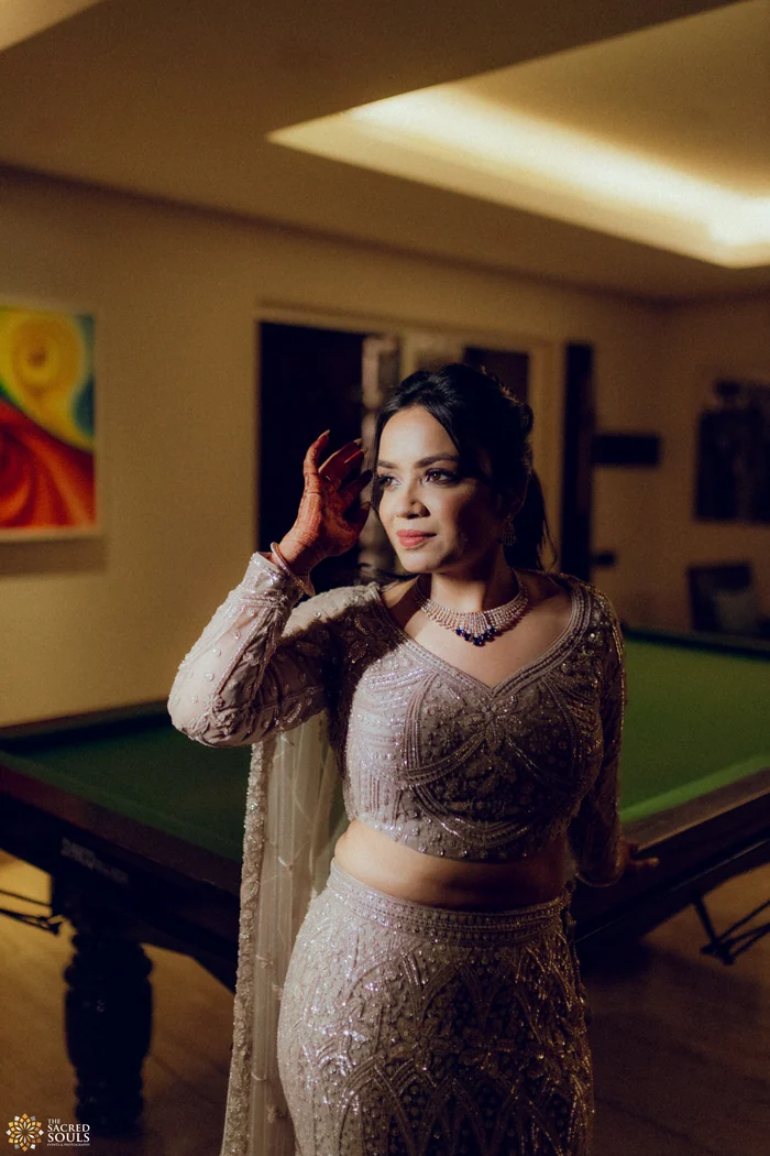 A woman in a sequinned gown in a dark room