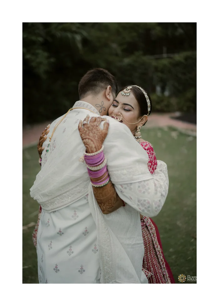 A bride and groom hugging in a garden