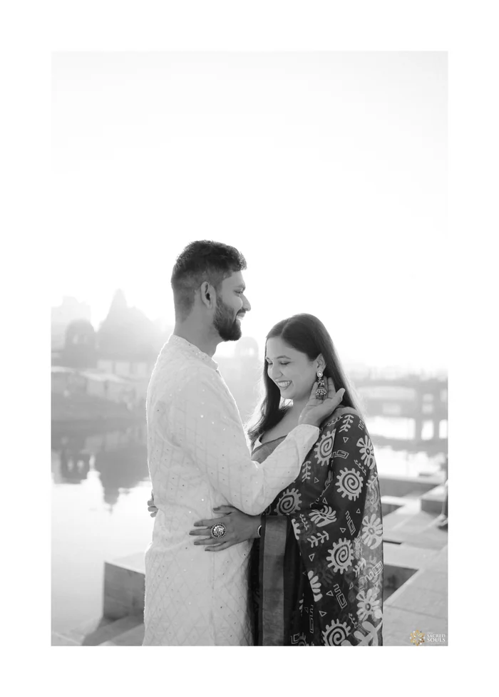 A black-and-white photo of a couple by a lake