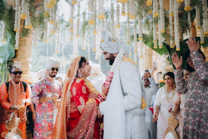 A bride and groom dancing in a lively wedding procession