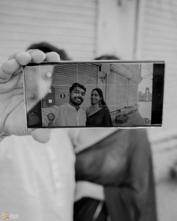 A black-and-white photo of a couple taking a selfie