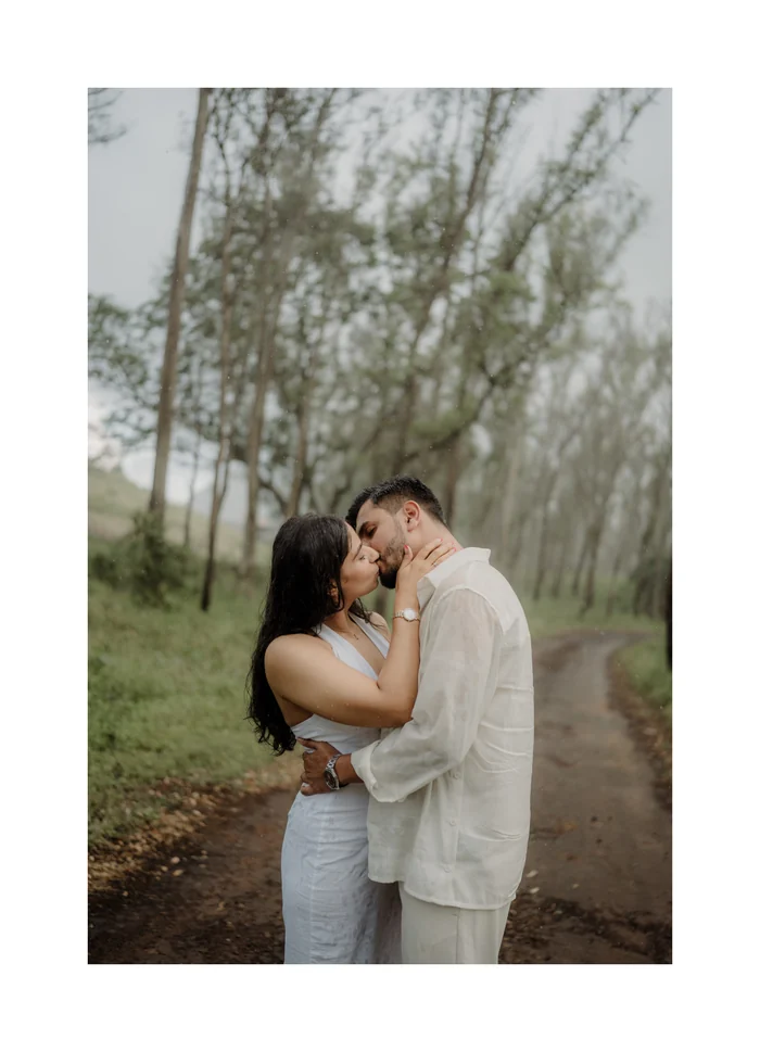 A couple about to kiss on a misty forest path