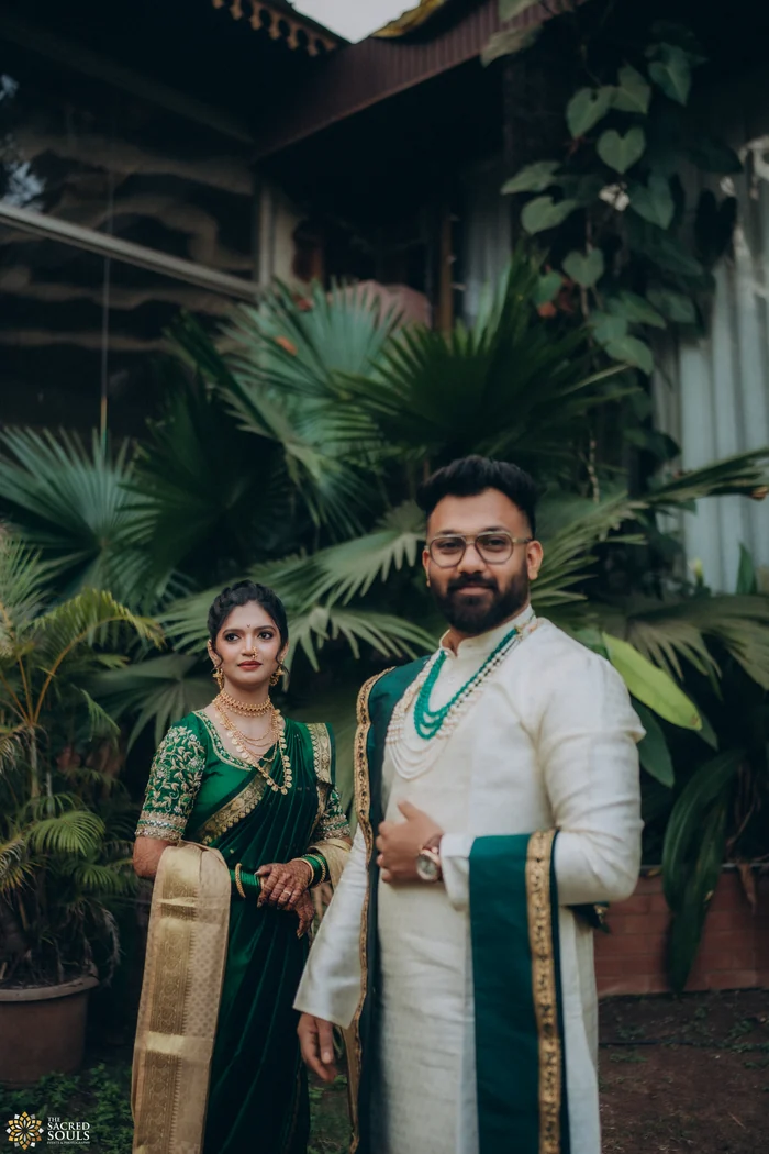 A couple in green and ivory among palm trees
