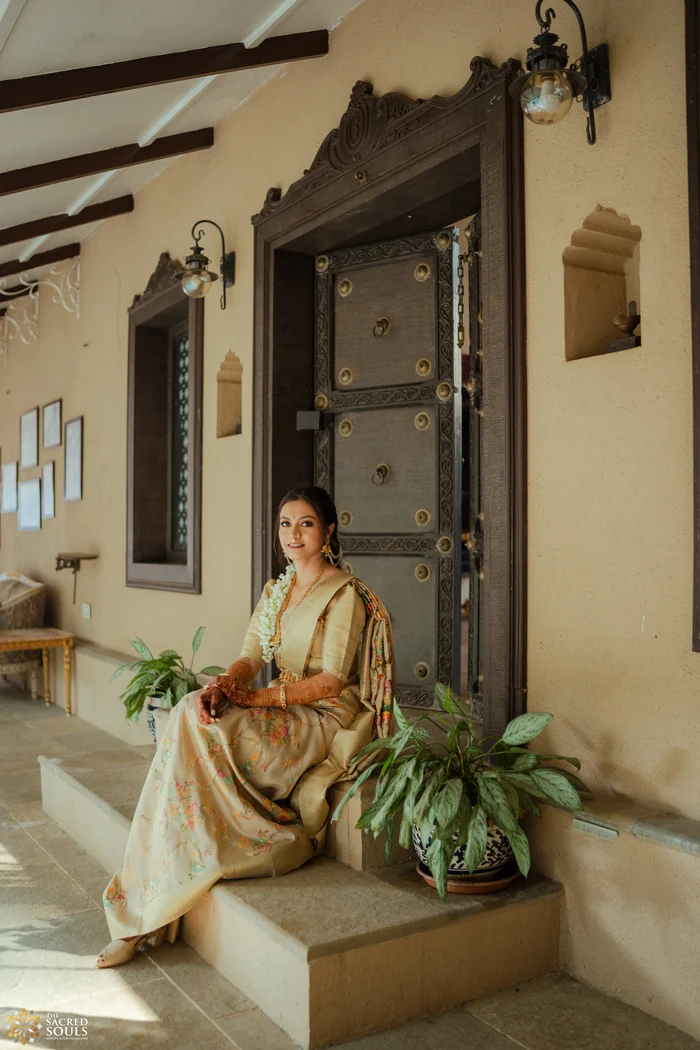 A bride sitting on the steps of a heritage house